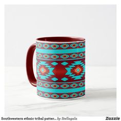 a red and blue coffee mug sitting on top of a white table