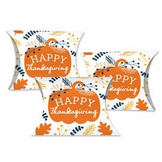 three pillows with happy thanksgiving pumpkins on the front and back, both in orange