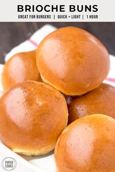 three buns sitting on top of a white plate next to a red and white napkin