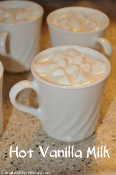 three white mugs filled with hot vanilla milk