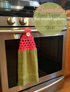 a towel hanging from the handle of an oven in front of a stainless steel stove