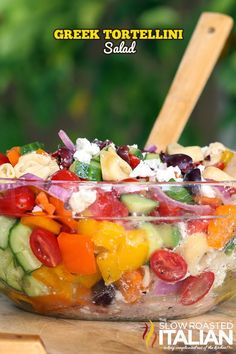 a bowl filled with lots of different types of food on top of a wooden table