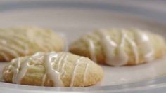 three cookies with icing in a plastic container