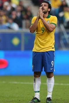 the soccer player is applauding his team's victory at the game in front of an audience