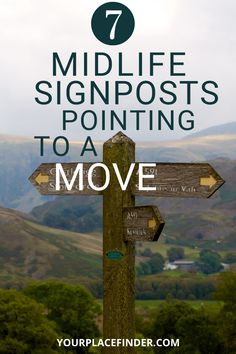 a wooden sign with the words 7 midlife signs pointing to a move