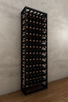 a wine rack with many bottles in it on a wooden floor next to a wall