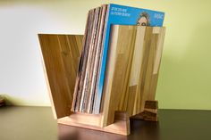 a stack of records sitting on top of a wooden stand