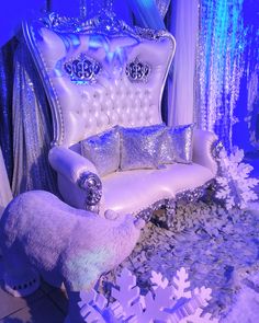 a white couch sitting next to a chair covered in snowflakes