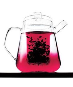 a glass tea pot filled with pink liquid