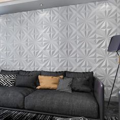 a black and white living room with geometric wallpaper