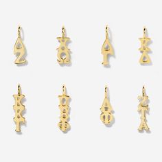 six gold pendants with chinese characters on them, all in different shapes and sizes