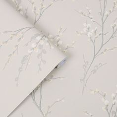 a wallpaper with white flowers on it and a light blue pen in the corner