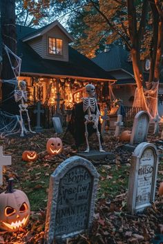 halloween decorations in front of a house with pumpkins and jack - o'- lanterns