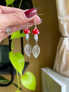 Nature Inspired Mushroom Earrings! Great gift Idea for nature lovers! -Cottagecore, mushroom and plant themed dangle earrings. -ALL HOOKS OF EARRINGS ARE NEW! -All my jewelry (except the earring hooks & wires) are created by me with recycled & up-cycled materials. -Mushroom is made out of glass. -Hooks are sterling silver, hypoallergenic. -All earrings are UNIQUE you get EXACTLY the one you see in the pictures! -I package the earrings in a box and then inside a bubble mailer for extra protection Mushroom Design Dangle Earrings For Gift, Mushroom Design Dangle Earrings As Gift, Red Nature-inspired Earrings For Gift, White Dangle Earrings With Mushroom Design, White Mushroom Design Earrings For Gift, White Mushroom Design Earrings As Gift, White Earrings With Mushroom Design As Gift, White Mushroom Design Drop Earrings, Nature-inspired Nickel Free White Earrings