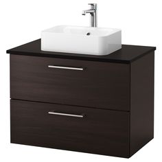 a bathroom sink sitting on top of a wooden cabinet next to a faucet