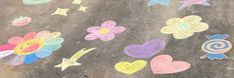 the sidewalk has been decorated with chalk and crayons to spell out flowers, hearts, and stars