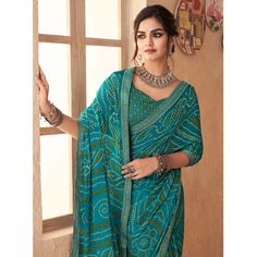 Blue colored saree is made from chiffon fabric which is highlighted with beautiful bandhani printed work with banarasi border as shown. comes along unstitched chiffon printed blouse piece which you can customise as per your design/style. Occasion - You can wear this saree for casual and daily. Note:- The actual product may differ slightly in color and design from the one illustrated in the images when compared with computer or mobile screen. Measurements: Saree : Chiffon : 5.5 Mtrs Blouse : Chiffon : 0.8 Mtr Material: Chiffon Stitch Type: Unstitched Country of Origin: India Care Guide: Dry Clean Multicolor Georgette Blouse With Bandhani Print, Bandhani Print Georgette Blouse Piece For Navratri, Blue Bandhani Print Unstitched Saree, Unstitched Blue Bandhani Saree, Unstitched Georgette Blouse With Bandhani Print, Blue Bandhani Print Traditional Wear In Georgette, Blue Georgette Traditional Wear With Bandhani Print, Blue Bollywood Bandhani Print Pre-draped Saree, Blue Bandhani Bollywood Pre-draped Saree