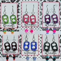 six pairs of earrings with different colors and designs on them, all hanging from hooks