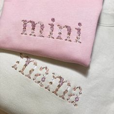 two pink and white shirts with the word mimi spelled in small sequins on them