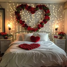 a heart shaped bed with red roses on the headboard and lights in the background