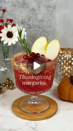 a thanksgiving margarita with apples and cinnamons on the table next to other holiday decorations