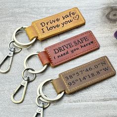 three leather keychains with the words drive safe and i need you here