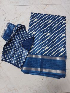 Dola Sequence work Silk Saree with all over white line print and boutique stitched blouse - Saree with blouse - Blouse size 36 (Self alter upto 40) Fabric  Saree : Dola sequence Silk Saree  Blouse: Silk material (Princess cut blouse) (Falls and Pico done) Color     : Saree - Blue with Cream                   Blouse - Blue Size       : 36 inches (Self alter Upto 40) Sleeve length : 16 Inches                              (sleeve round measurement in end 12 inches) Neck      : Front 4 inches, Back Semi-stitched Blouse With Printed Motifs For Diwali, Festive Chanderi Blouse With Bandhani Print, Diwali Semi-stitched Blouse With Printed Motifs, Festive Ikat Print Blouse, Semi-stitched Chanderi Blouse With Bandhani Print, Festive Blue Bandhani Print Blouse, Navratri Ikat Print Blouse Piece For Saree, Navratri Blouse With Printed Motifs, Festive Ikat Print Blouse For Festivals