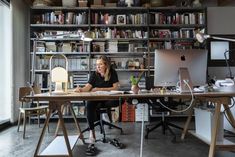 a woman sitting at a desk in an office