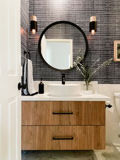 a bathroom with a sink, mirror and toilet