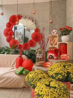 a living room filled with lots of red and yellow decorations