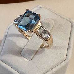 Solid 14k Gold London Blue Topaz & Sky Blue Ring Beautiful Deep Blue Teal Rectangular Cut Topaz Stone Guessing It’s About 2 Carats ~9.1x7.5mm Two Beautiful Sky Blue Topaz On Each Side Of Center Stone Stamp 14k December Birthstone Euc Minor Scratches On Gold Due To Normal Wear. Ring Size Approximately 8 Appropriate Total Gram Weight 3.76 Stone Color Changes Depending On The Lighting Poshmark Authenticates Items Over $500 For Free Plus Free Shipping On Items Over $500. Shipping Same Day Or Next Da Blue Ring, Modern Engagement Rings, Second Hand Stores, Sky Blue Topaz, Topaz Stone, December Birthstone, Beautiful Sky, Blue Teal, London Blue Topaz