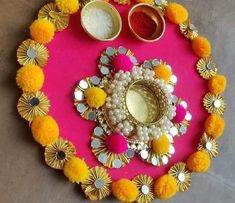 a pink tray with yellow and white pom poms