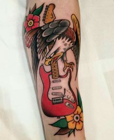 a person with a guitar tattoo on their arm