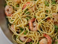 pasta with shrimp, peas and broccoli in a bowl