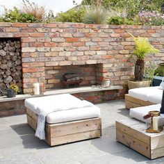 an outdoor patio with two couches and a fire place