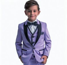 a young boy wearing a purple suit and bow tie