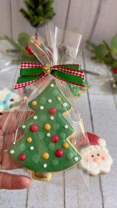 a hand holding a decorated christmas tree ornament