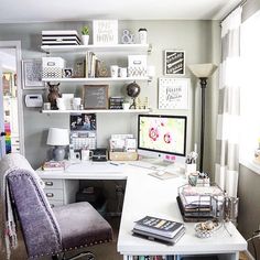 a desk with a computer, chair and books on it in front of a window