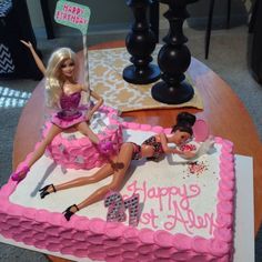 a birthday cake with barbie dolls on it