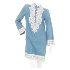 Gucci Blue Cotton-Linen Chambray and Lace Tunic Dress Blue/White Chambray fabric Lace appliqué trim Long bell sleeves Tunic neckline with button fastening Shift silhouette Mini length Made in Italy 65% cotton, 35% linen fabric, 76% cotton, 24% polyester decoration; 83% cotton, 17% polyamide trimming Great preowned condition; minimal signs of wear Size & Measurements Approximate, taken flat: Size IT 40; estimated US Size 4 Shoulder to Shoulder: 16" Bust: 17" Waist: 18.5" Hips: 19" Sleeves: 18" Fr Lace Tunic Dress, Chiffon Ruffle Dress, Chambray Fabric, Slim Aarons, Silk Chiffon Dress, Long Bell Sleeves, Lace Tunic, Gio Ponti, Shopping Photography