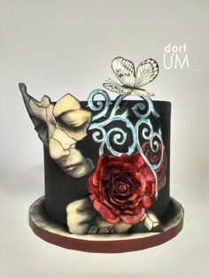 a black and red cake with flowers on it