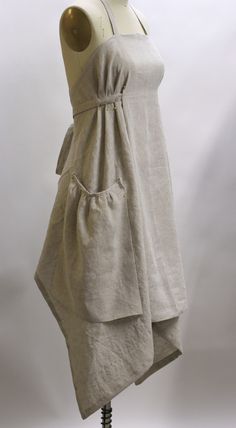 a dress on a mannequin with a white shirt hanging from it's back