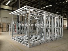 a large metal structure sitting inside of a warehouse