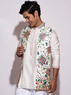 This White Open Bundi Jacket Set will instantly give an elegant look. This 2 piece open bundi jacket set features a white open bundi jacket with colorful floral work, and a mandarin collar. The white color with heavy floral embroidery and silk fabric enhance this bundi jacket set. It is paired with white slim-fit pants. An ideal outfit for traditional occasions, and special events.

Size Chart For Men





	
	
					Men's Size Chart
		

		
		
						
				Size Chart For Men
				Custom Size Measurem Blue Prom Suits For Guys, Blue Prom Suit, Indian Wedding Suits Men, Haldi Outfit, Kurta Style, Floral Work, Wedding Outfit Men, Indian Men Fashion, Wedding Branding