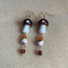 - Dangly Earrings Featuring Brown/White Mushroom Shaped Beads, Brown/White Round Glass Beads , And Orange Semi-Precious Beads - Handmade (By Myself) And Packaged With An Earring Card, Wrapped In A Cellophane Bagperfect For Gifts! -Beads Are Glass And Semi-Precious Material - Earring Cards Are 6cm (Width) And 9cm (Length) For Size Reference - On Gold Fishhook Earring Hooks Check Out My Closet For More Handmade Jewelry Tags: Boho Earrings, Dangly Earrings, Dangle Earrings Floral Earrings, Flower, Mushroom Earrings Beads, Pearl Pendant Earrings, White Mushroom, Apple Earrings, Pink Heart Earrings, Bunny Earrings, Ghost Earrings, Gold Earrings For Women, Earring Card