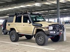 a beige four door suv parked in a parking garage