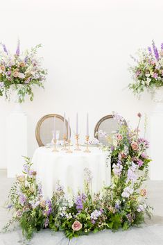 a table with flowers and candles on it