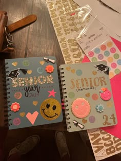 an open notebook sitting on top of a wooden table next to other papers and magnets