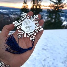 a person holding up a snowflake in their hand