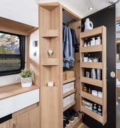 the inside of a travel trailer with shelves and drawers